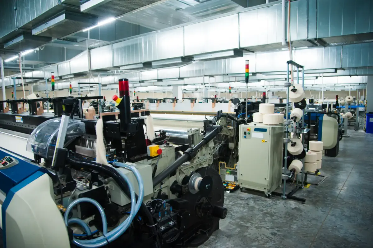 Planta industrial con maquinaria textil en producción
